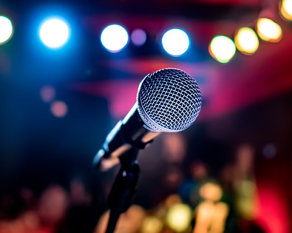 Microphone on stage against a background of auditorium